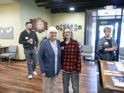 Picture of church family members mingling in the lobby before service.