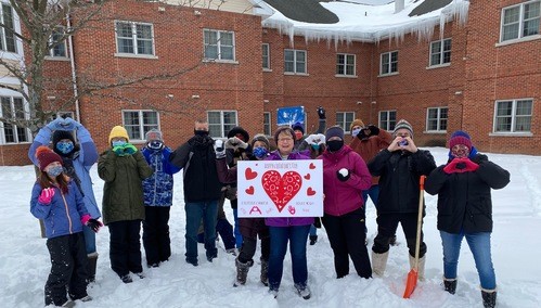 Picture of church members standing in front of a senior-living center where they were bringing holiday joy. 