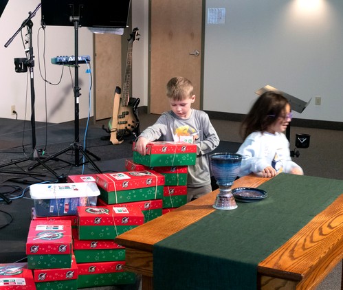 Picture of kids setting up Operation Christmas child boxes in the sanctuary 