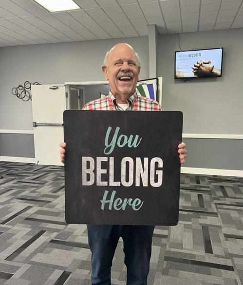 Man holding sign reading, 
