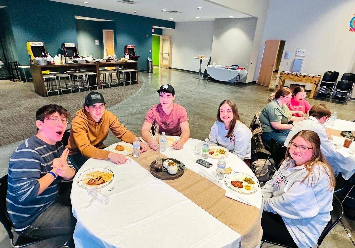 Young adults eating together around a table