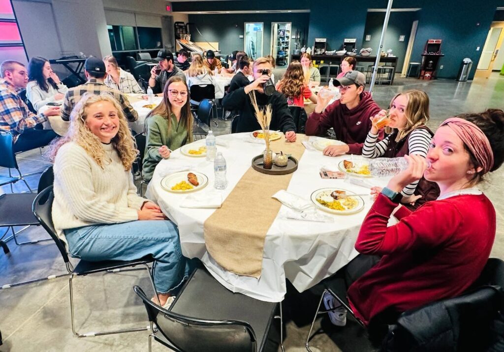 Young adults gathered at tables