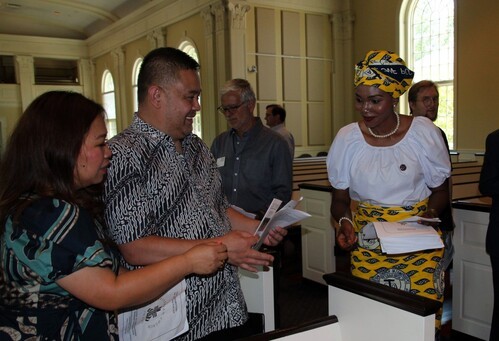 Church members holding a service bulletin